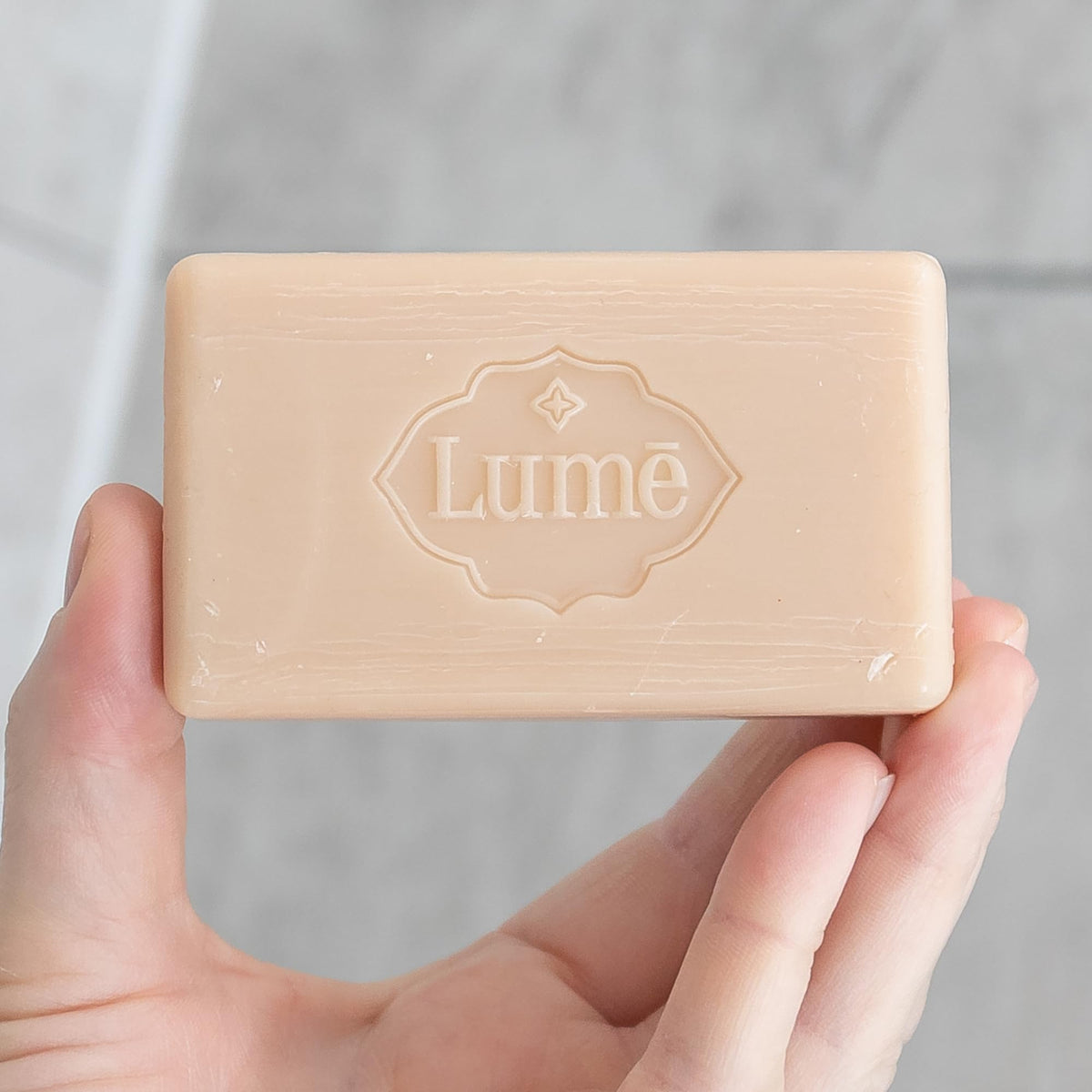 Lume bar staged in bathroom setting suggesting daily ritual and floral freshness