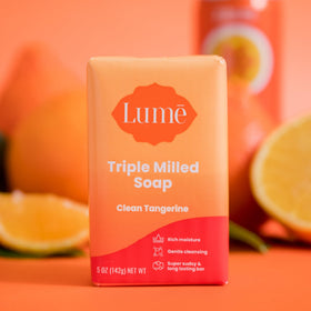 Hand holding Lume 5 oz bar to demonstrate true size and scale