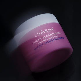 Hand applying Lumene cream with finger demonstrating lightweight spreadable formula benefit quick absorption