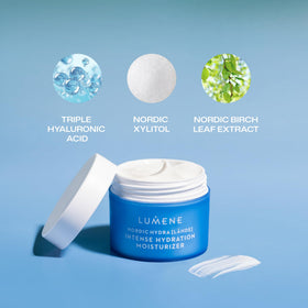 Cream dispensed on fingertip from Lumene jar demonstrating spreadable, non-greasy hydration