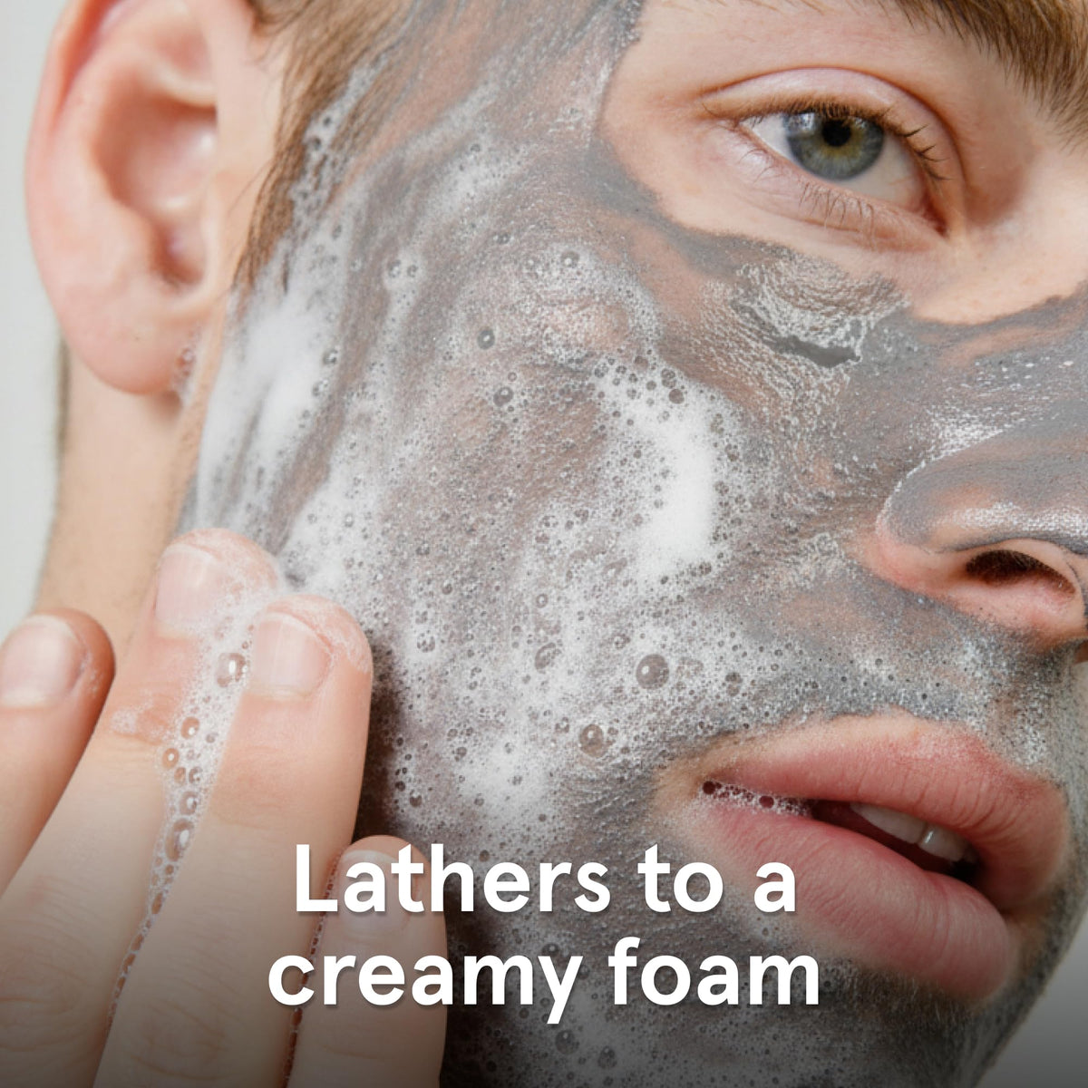 Lumin charcoal face wash foaming in hand demonstrating easy lathering benefit