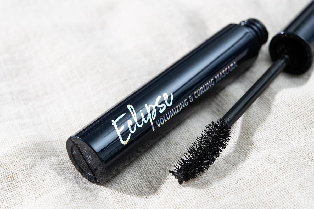 Lune+Aster Eclipse tube next to a coin showing compact size and travel-friendly benefit