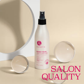 L LUSETA glossy pearl texture drops on fingertip showing lightweight, hydrating formula