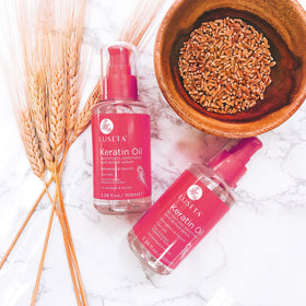 Luseta serum on bathroom vanity beside styling tools for daily routine benefit