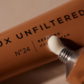 Lux Unfiltered open tube cream drop showing rich formula and targeted coverage benefit