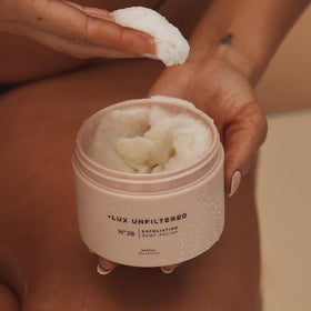 Lux Unfiltered scrub being applied in shower delivering smooth skin
