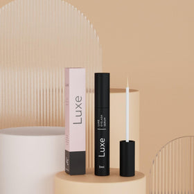 LUXE demonstration applying serum to upper lash line for growth support