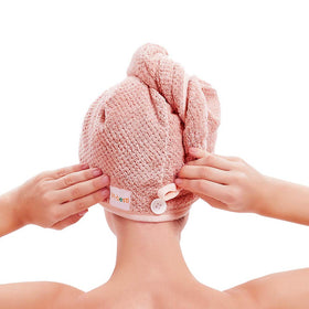 M-bestl button and tie-loop detail securing turban to prevent slipping during use