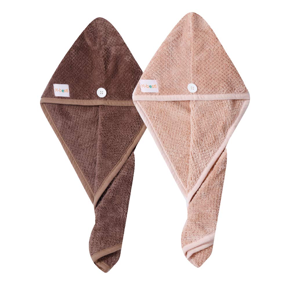 M-bestl towel next to a hand to illustrate 25x65 cm size and coverage for most heads