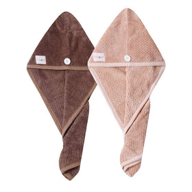 M-bestl towel next to a hand to illustrate 25x65 cm size and coverage for most heads
