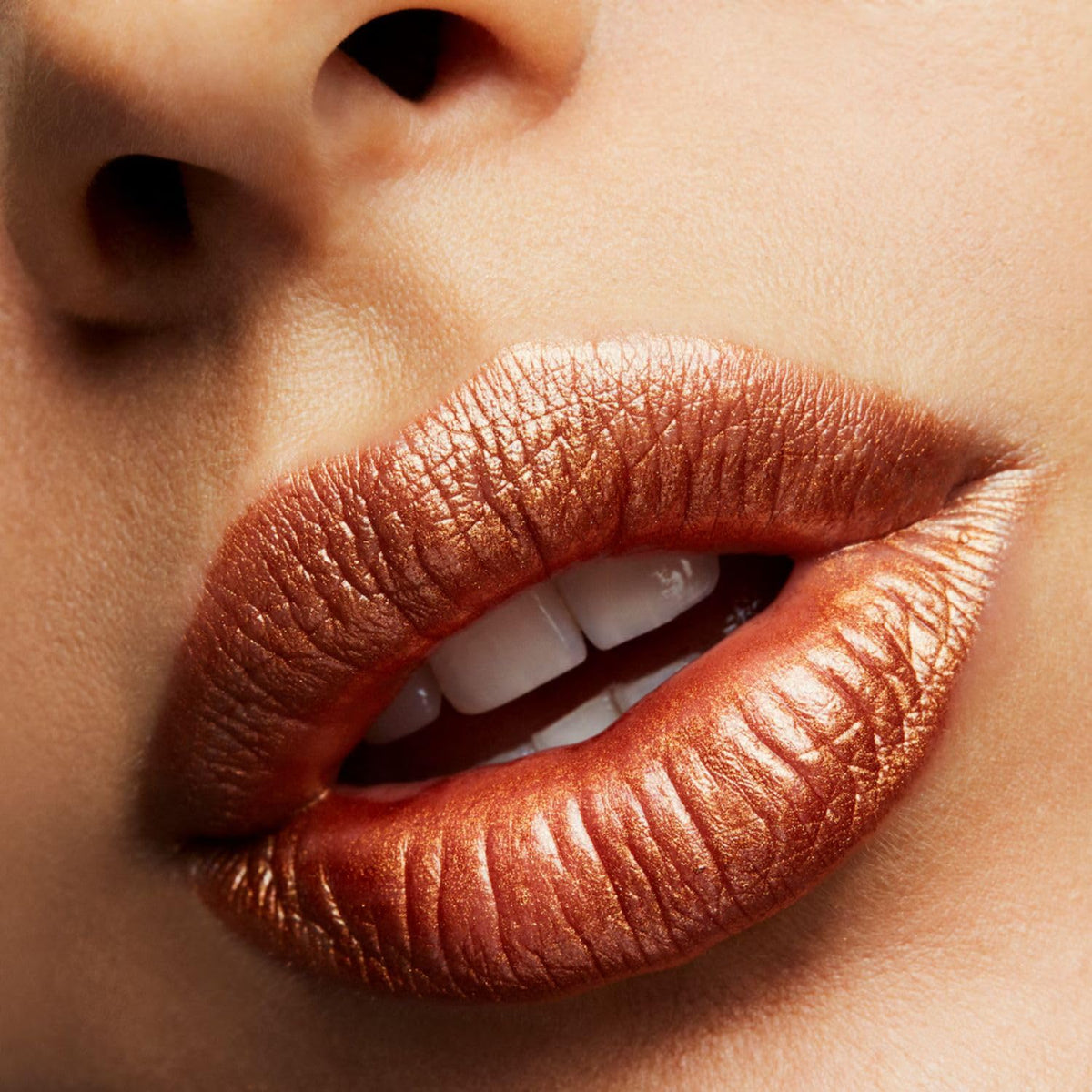 MAC Bronze Shimmer lifestyle portrait on model illustrating wearable bronze shine for polished everyday looks