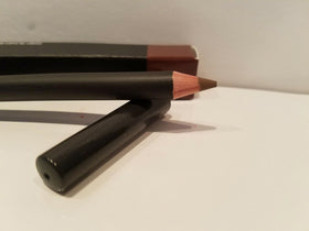 MAC lip pencil angled to show printed label Cork highlighting brand and shade information