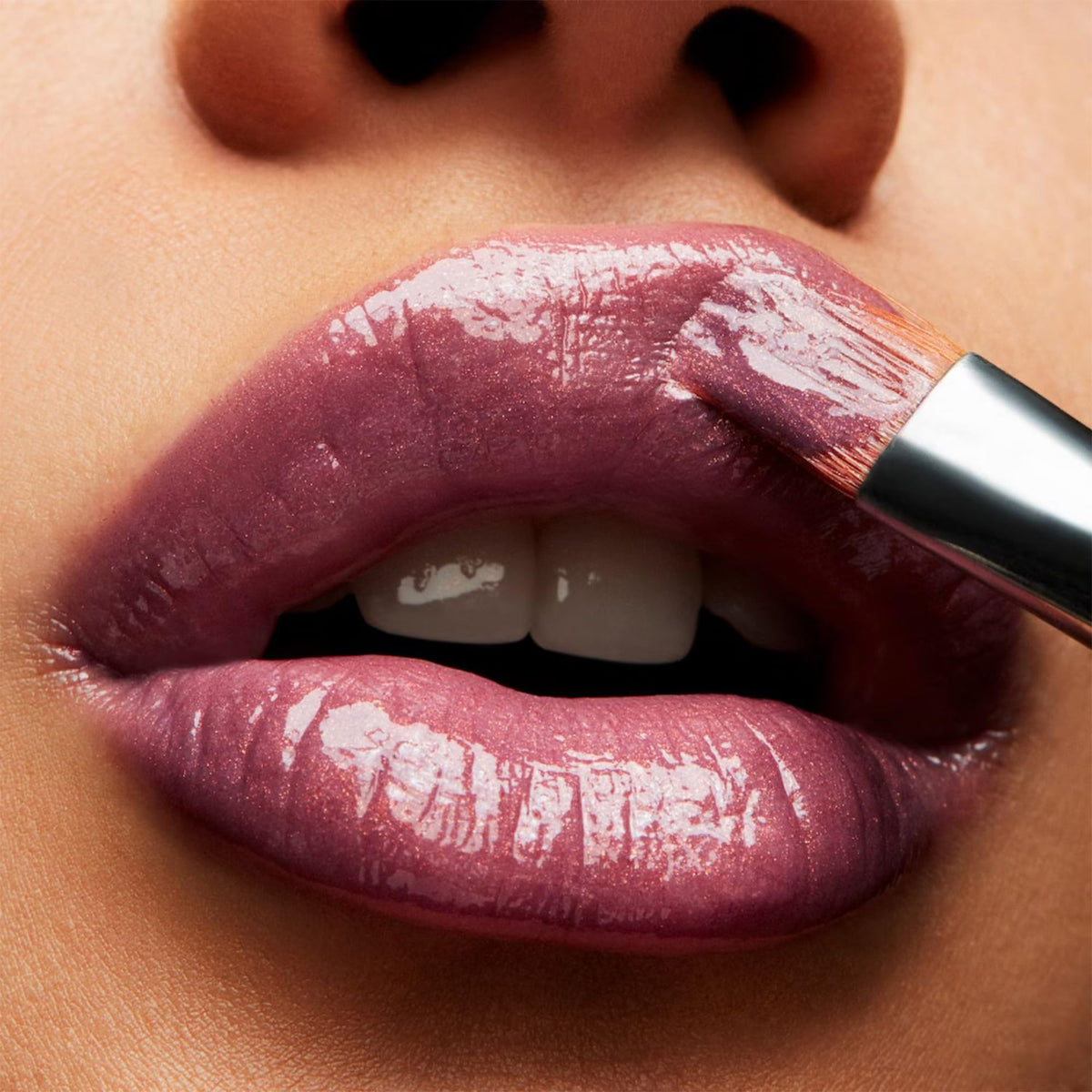 MAC LOVECHILD tube close-up displaying glossy texture and color benefit