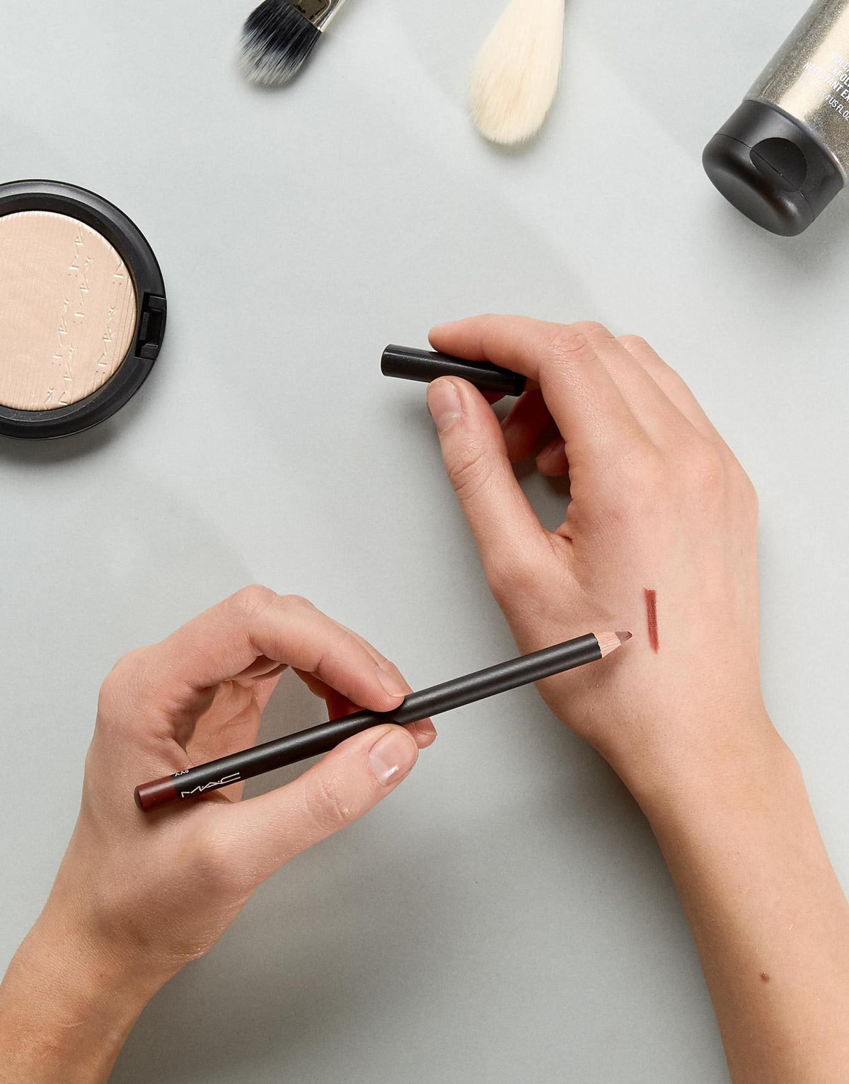 MAC mahogany swiped on lips showing rich color and long-wear benefit