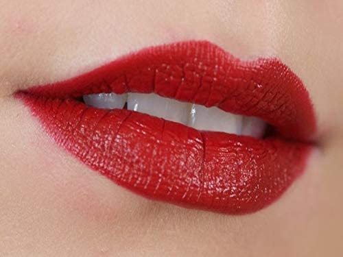 Model wearing MAC lipstick evening look demonstrating lasting bold color