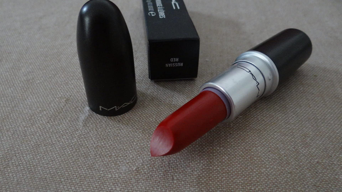 MAC lipstick next to hand to show scale and travel-friendly 0.1 oz size