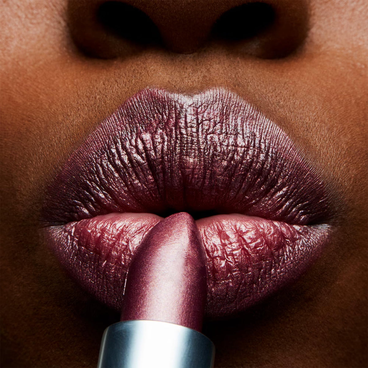 MAC texture swatch of Plum Dandy on skin showing shimmer benefit: visible pearl finish