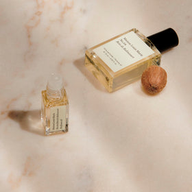 Maison Louis Marie roll-on held by hand to demonstrate 15 ml travel-sized convenience