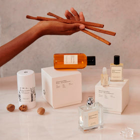 Maison Louis Marie No.04 beside a hand showing 3ml sample scale for easy portability