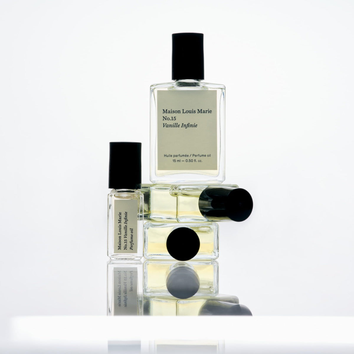 Maison Louis Marie roll-on oil in hand to show the small travel-friendly 3ml size