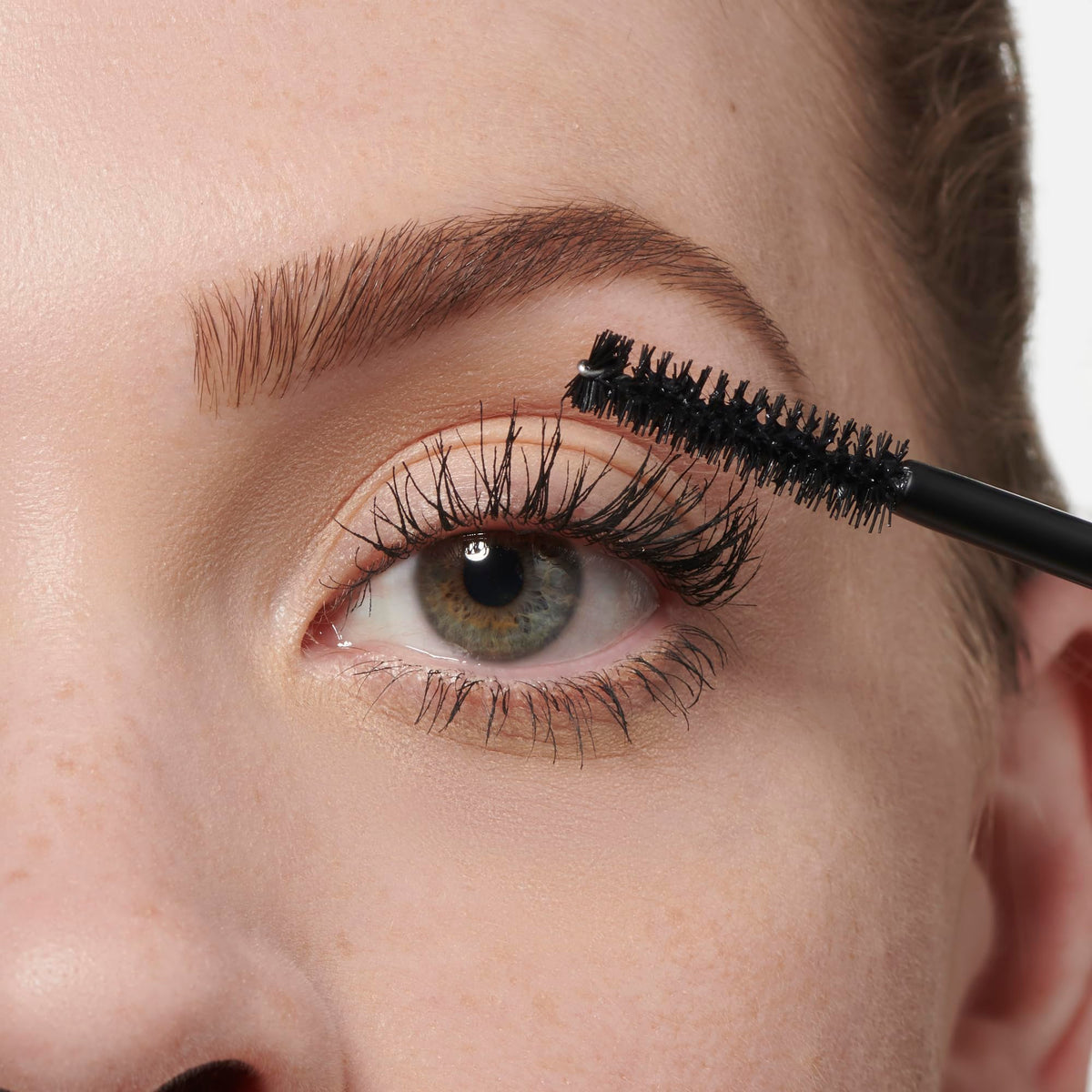 Makeup Revolution brush loaded with formula, showing texture for smooth layered coverage