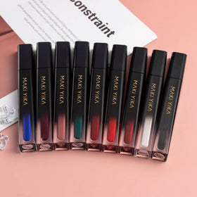 MAKI YIKA lipstick next to a coin showing compact tube size for travel convenience