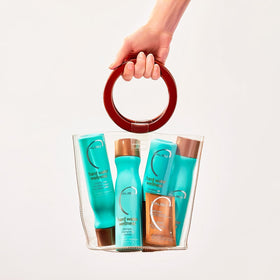 Malibu C travel bottle on bathroom shelf highlighting convenience for trips