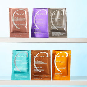 Malibu C packet next to hand showing packet size and travel-friendly benefit