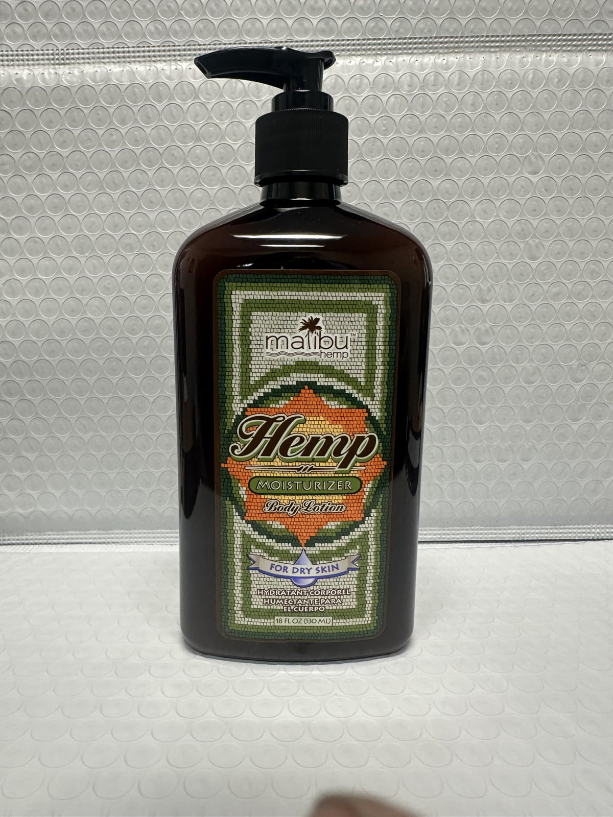 Malibu Tan label close-up highlighting hemp-derived components and moisturizing features