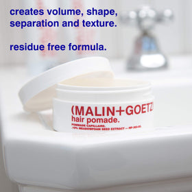 MALIN+GOETZ applied to hair demonstrating controlled texture and tamed flyaways benefit