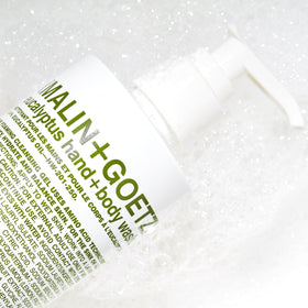 MALIN+GOETZ bottle on shower shelf illustrating practical daily-use convenience