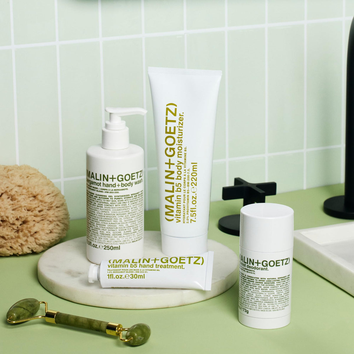 MALIN+GOETZ bottle on bathroom shelf in morning scene conveying daily routine compatibility