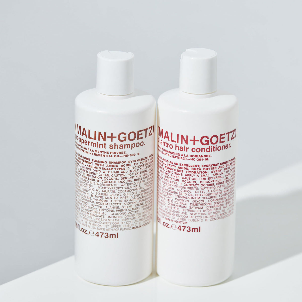 MALIN+GOETZ bottle on bathroom shelf styled in lifestyle setting for routine-friendly appeal