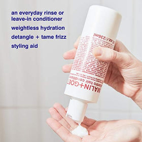 MALIN+GOETZ conditioner in shower being applied to wet hair for detangling benefit