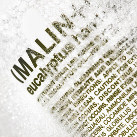 MALIN+GOETZ label detail with ingredients list showing transparent formulation benefit