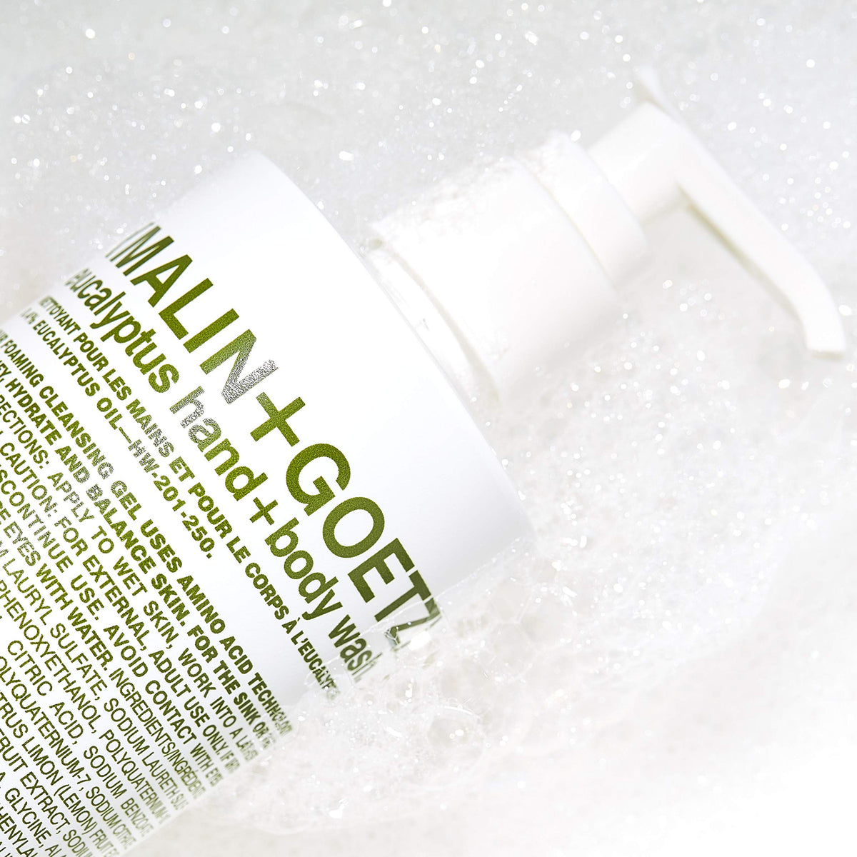 MALIN+GOETZ gel pouring from bottle to show lightweight formula and easy rinse benefit