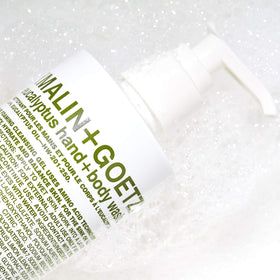 MALIN+GOETZ gel pouring from bottle to show lightweight formula and easy rinse benefit