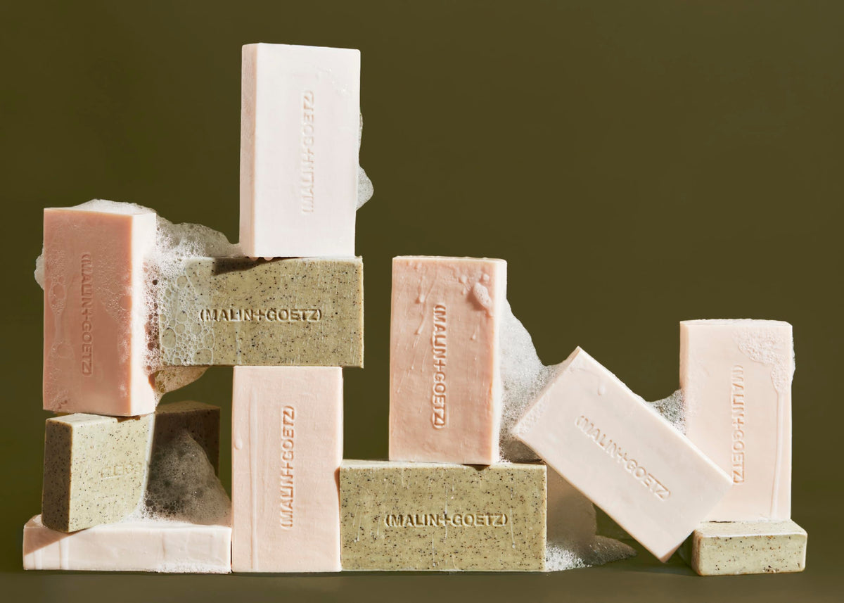 MALIN+GOETZ bar held in hand for size and longevity comparison benefit