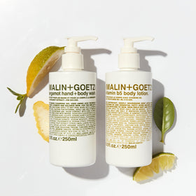 MALIN+GOETZ applying lotion to arm to show quick hydration and non-greasy finish