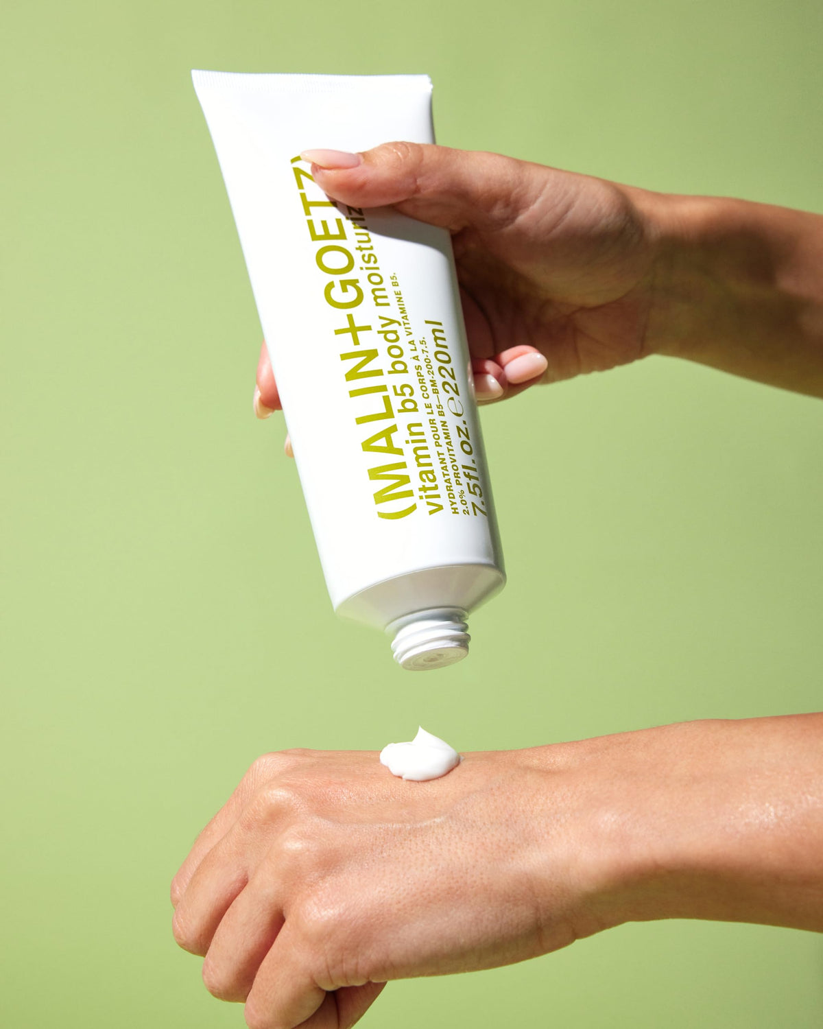 MALIN+GOETZ label close-up featuring ingredient highlights like provitamin B5 and shea butter