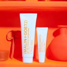 MALIN+GOETZ label close-up highlighting zinc oxide, titanium dioxide, and key moisturizing actives
