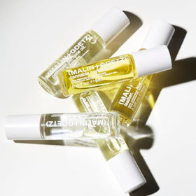 MALIN+GOETZ cedarwood and sandalwood ingredients staged to show warm woody base benefit