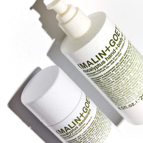 MALIN+GOETZ bottle styled on bathroom counter conveying premium unisex aesthetic