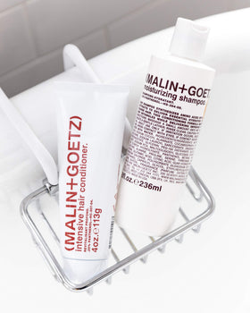 MALIN+GOETZ shampoo in bathroom setting showing everyday hydration ritual