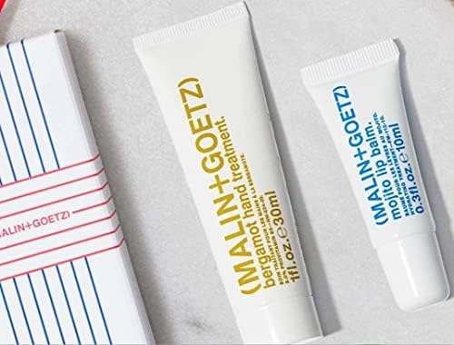 MALIN+GOETZ held in hand to show compact 0.35 fl oz travel-friendly size
