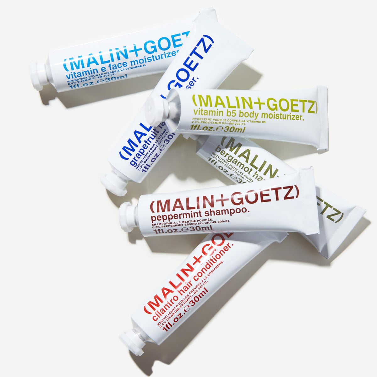 MALIN+GOETZ peppermint shampoo pouring from tube showing refreshing scalp benefit