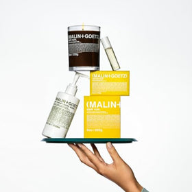 MALIN+GOETZ 8.5oz bottle in travel bag for portability and everyday convenience