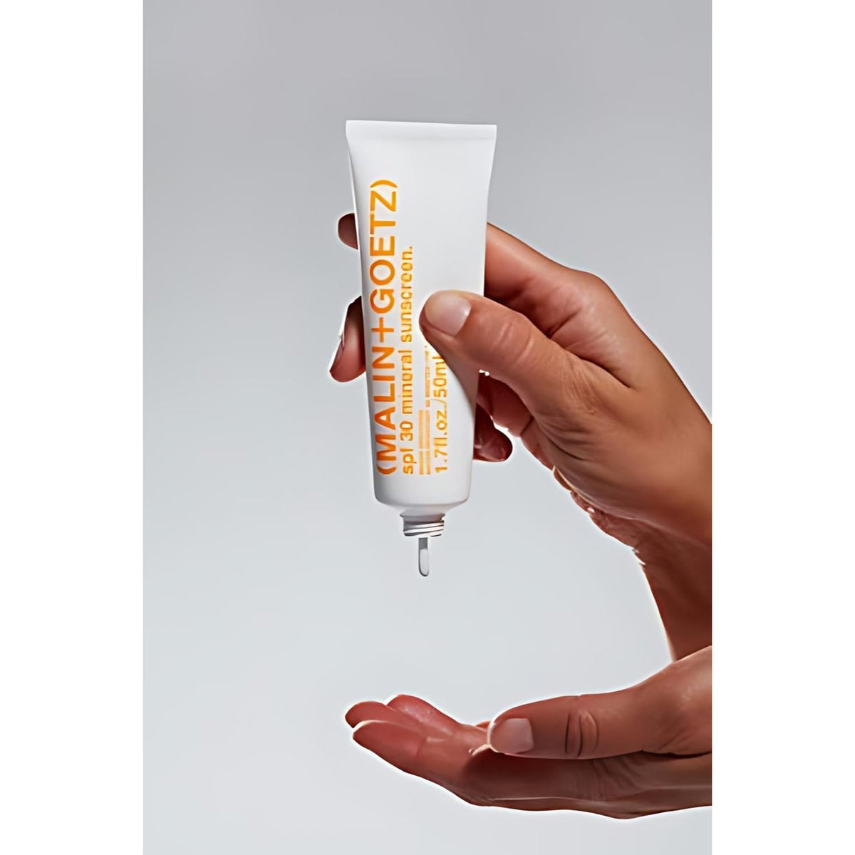 MALIN+GOETZ next to a ruler showing the 1.7 fl oz scale for travel convenience and portability