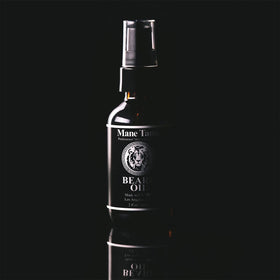 Mane Tame oil drops on hand displaying lightweight texture and fast absorption