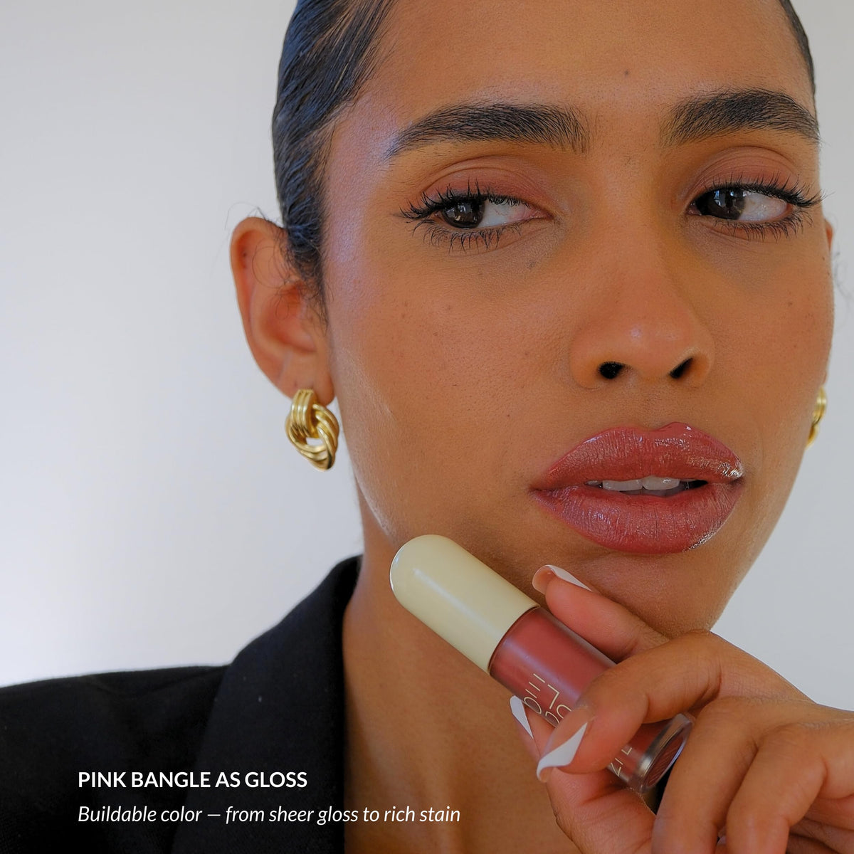 Mango People tube next to coin showing compact size and travel friendly benefit